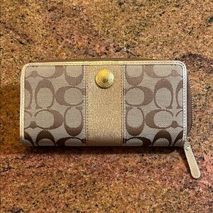 Used COACH wallet. Gold and brown. Some stains. Have not tried to clean it.